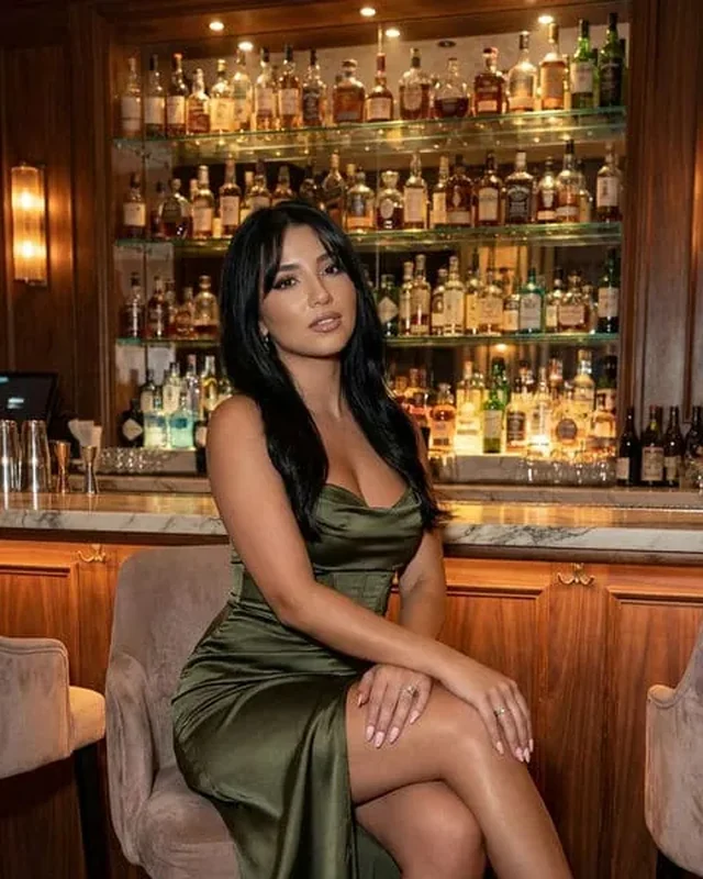 Goddess Lila, a verified findom profile in an elegant green evening dress